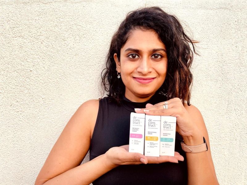 Founder Malini Adapureddy holding Deconstruct serums